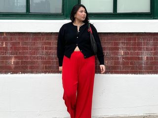 Girl wearing red pants and black cardigan