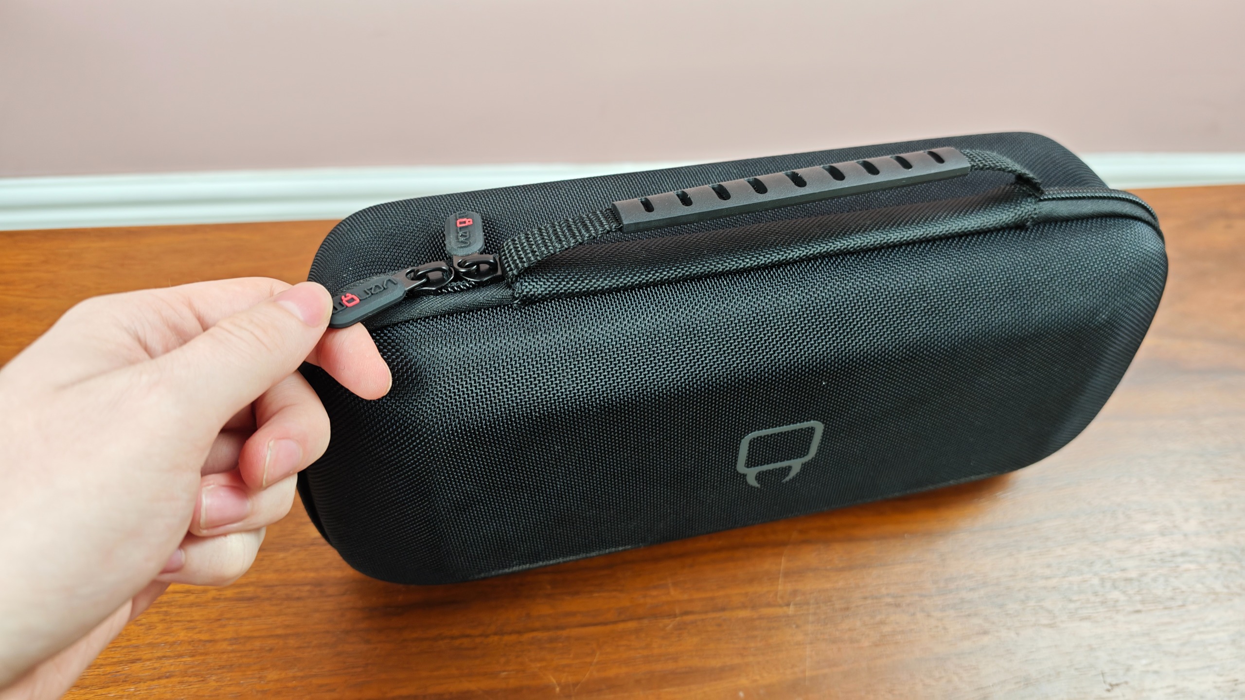 Man zipping up the Venom PlayStation Portal Carry Case