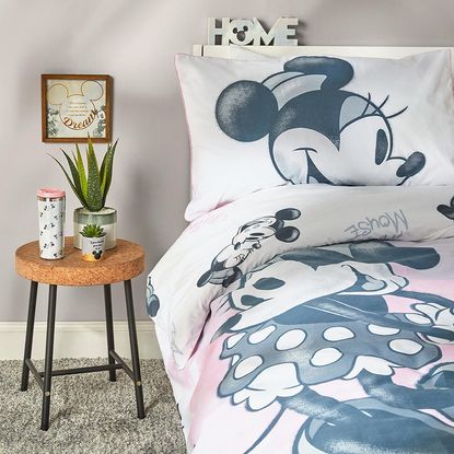 bedroom with mickey mouse bedding and carpet flooring