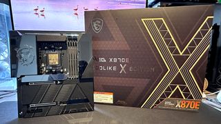 A photo of an MSI MEG X870E Godlike X Edition, next to its retail box