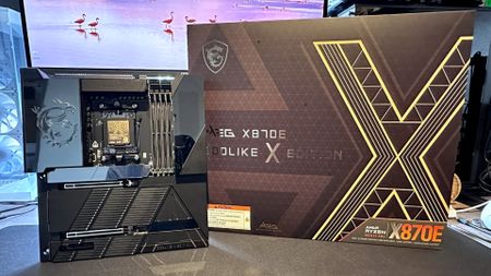 A photo of an MSI MEG X870E Godlike X Edition, next to its retail box