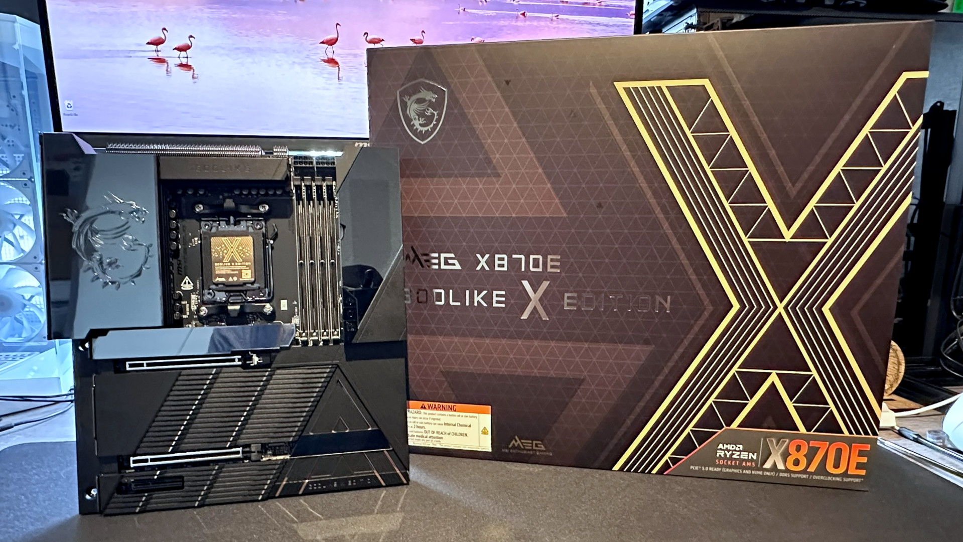A photo of an MSI MEG X870E Godlike X Edition, next to its retail box