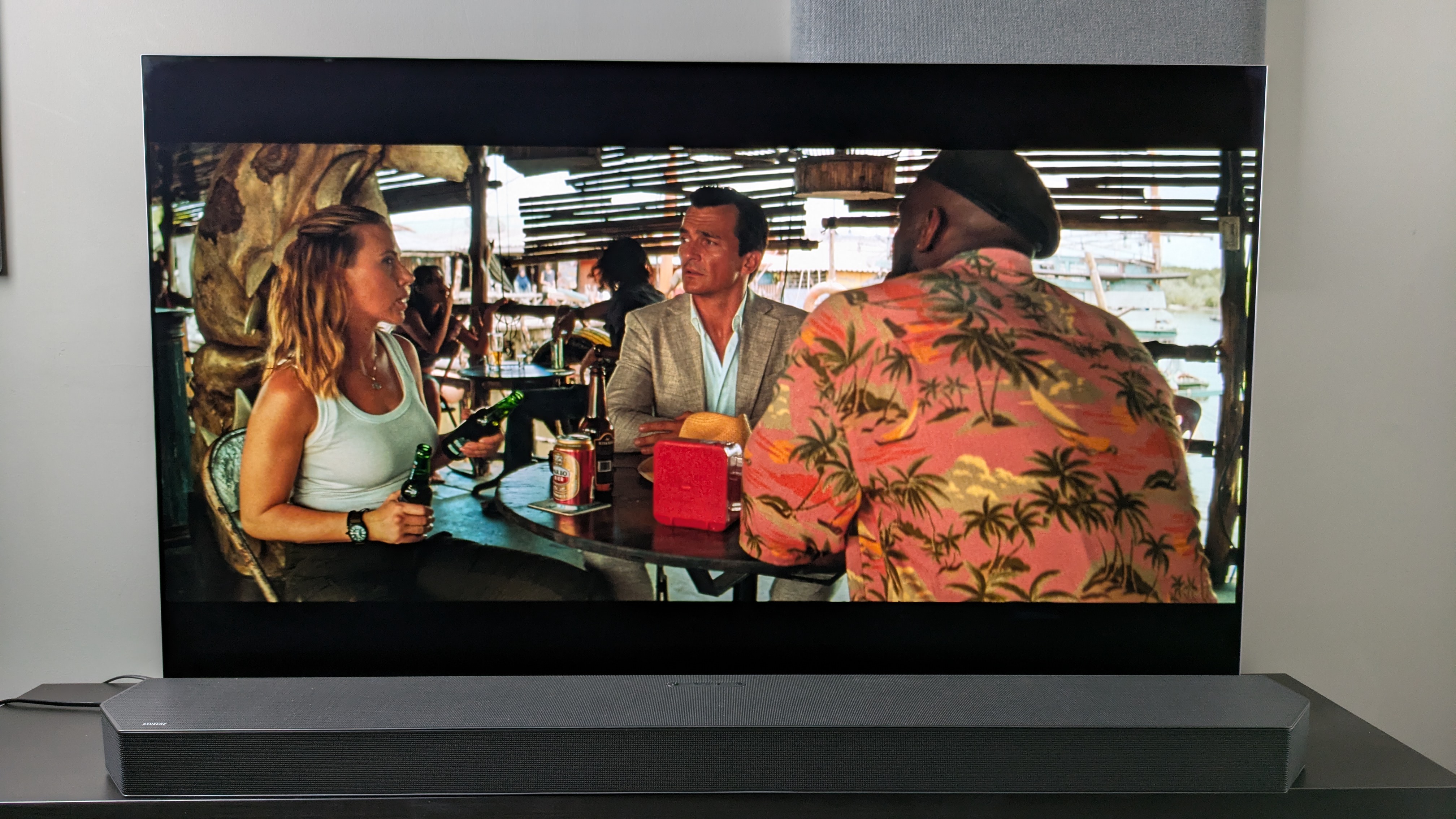 A shot of Zora, Duncan and Martin sat at a bar from Jurassic World: Rebirth 4K Blu-ray on LG G5 screen