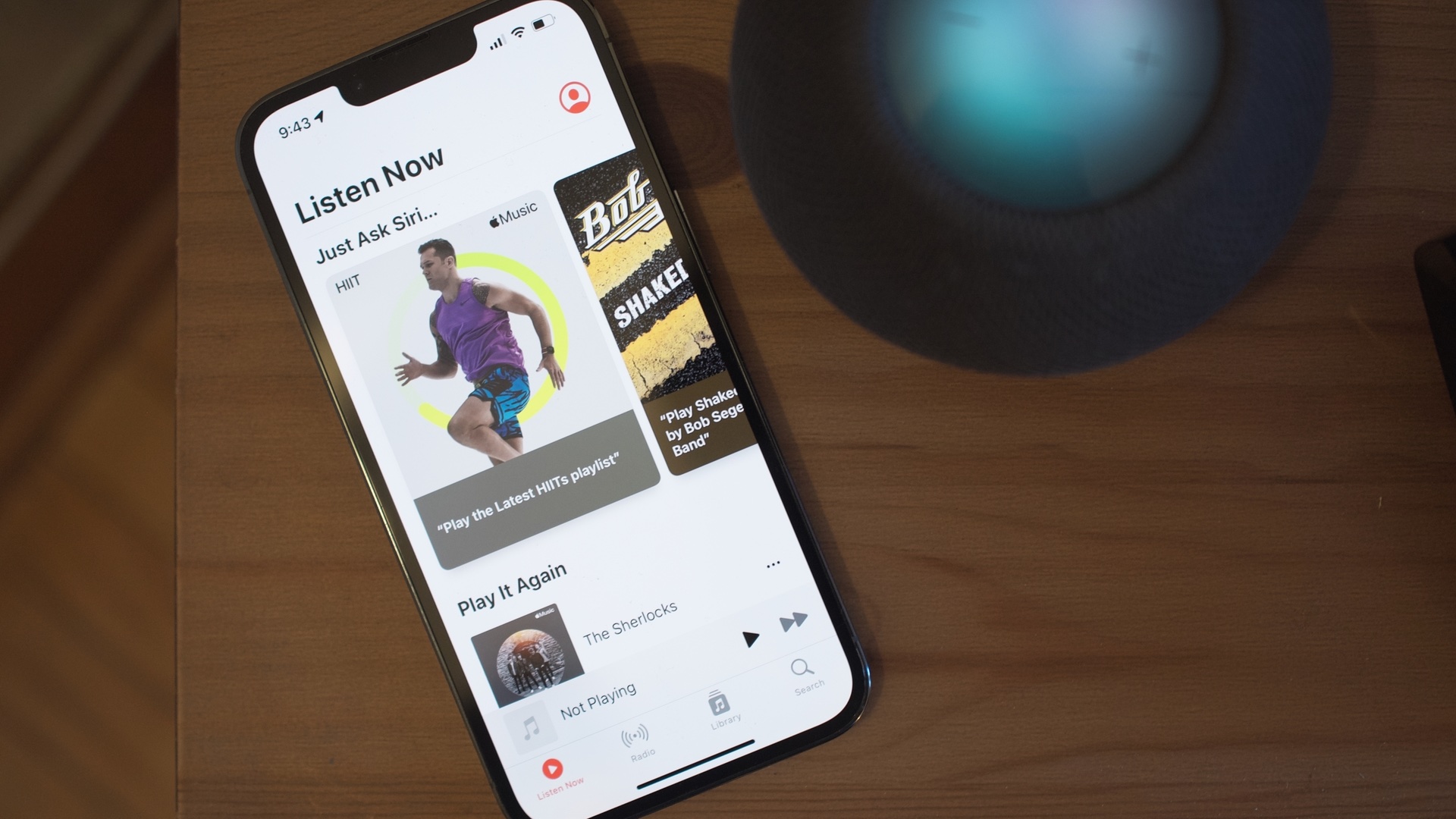 Apple Music on iPhone beside HomePod mini