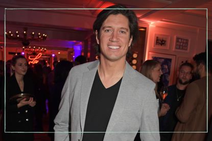 a close up of new BBC Radio 2 host Vernon Kay smiling for the camera, wearing a grey blazer