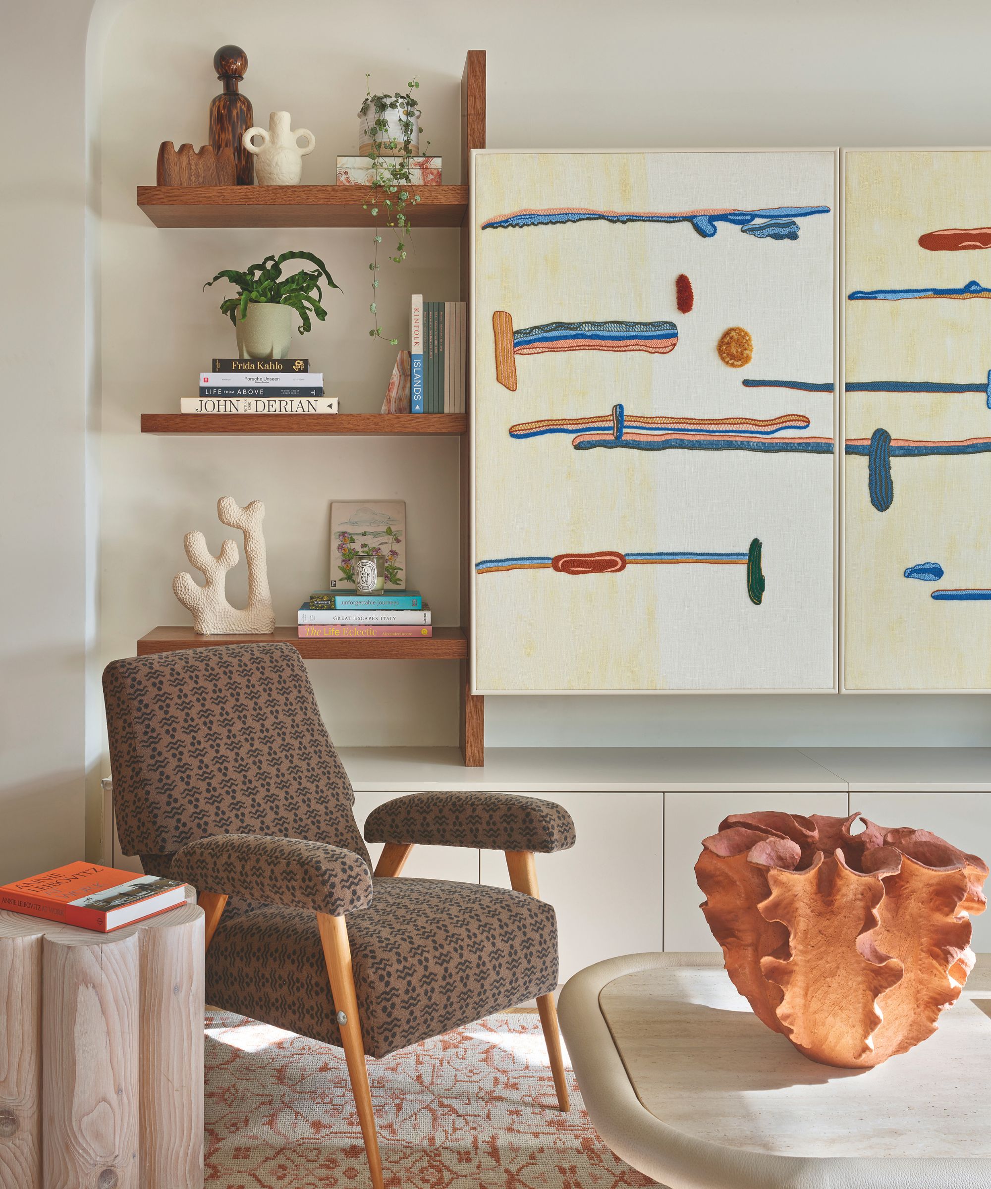 armchair in corner with shelving unit with objects
