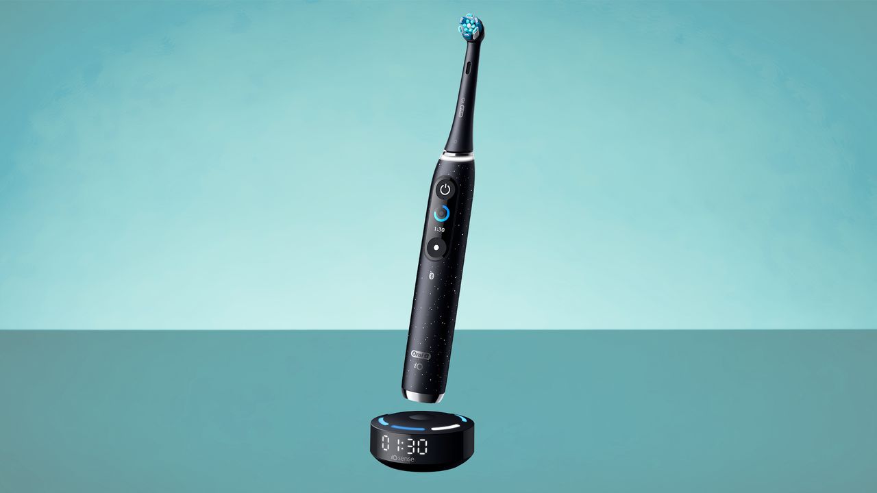 Oral-B iO10 electric toothbrush on green background