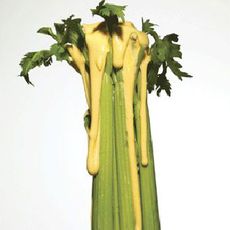 A bunch of celery covered in dressing