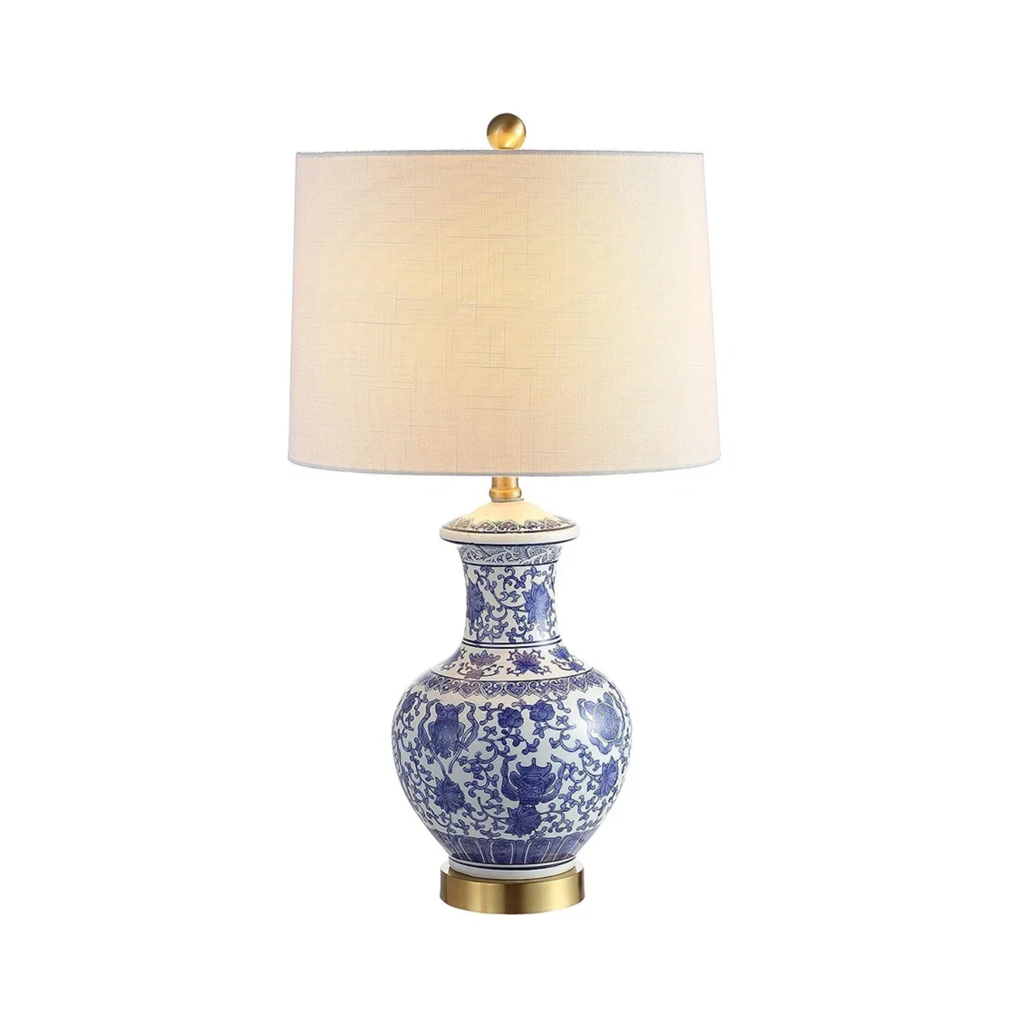a lamp with a blue and white decorative base and a white shade