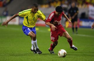 Turkey's Yildiray Basturk holds off Brazil's Gilberto Silva in the teams' 2002 World Cup semi-final.
