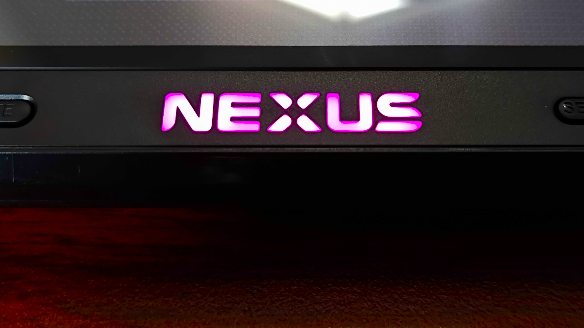 Close up of Evercade Nexus logo with RGB lighting set to purple.