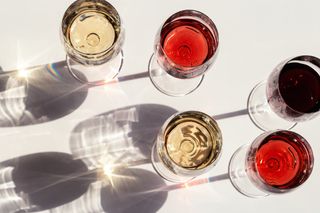 Perimenopause symptoms: Red, rose and white wine top view in sunlight. Dark shadows