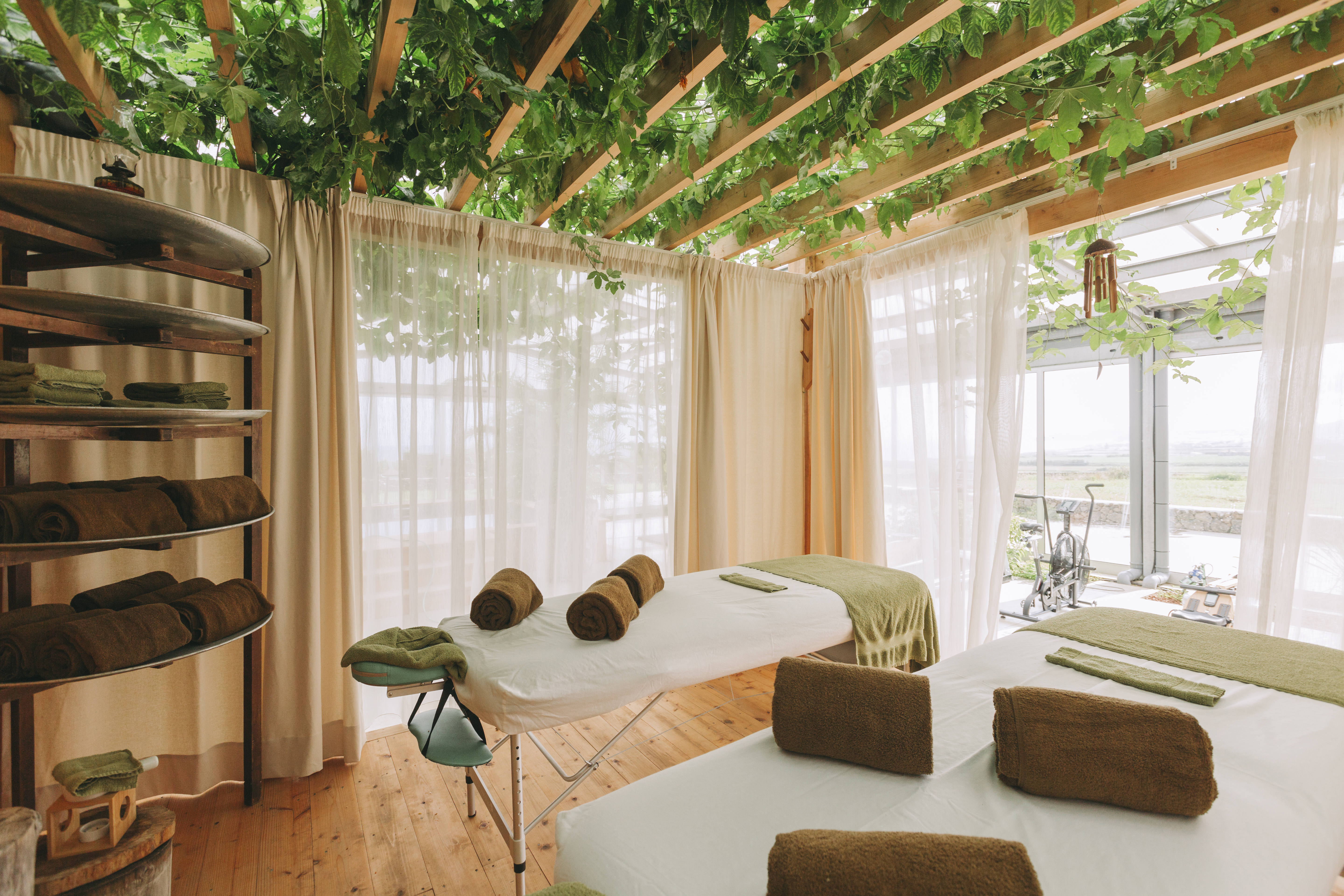 An eco-resort punctuated by wooden finishes, thriving plants, and mid-century modern furniture, as well as breathtaking coastal views.