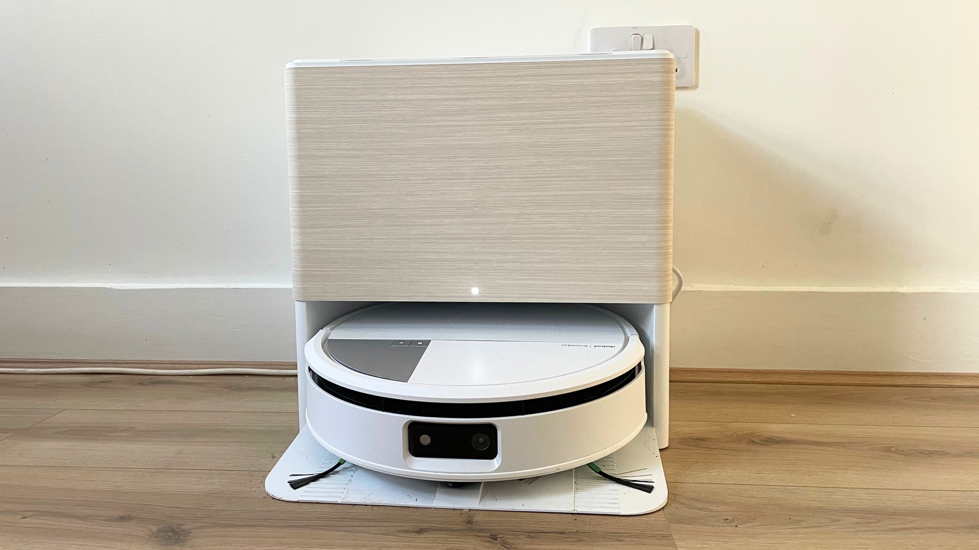 iRobot Roomba Max 705 Robot Vacuum Cleaner and Mop on wood-effect flooring, in front of a white wall