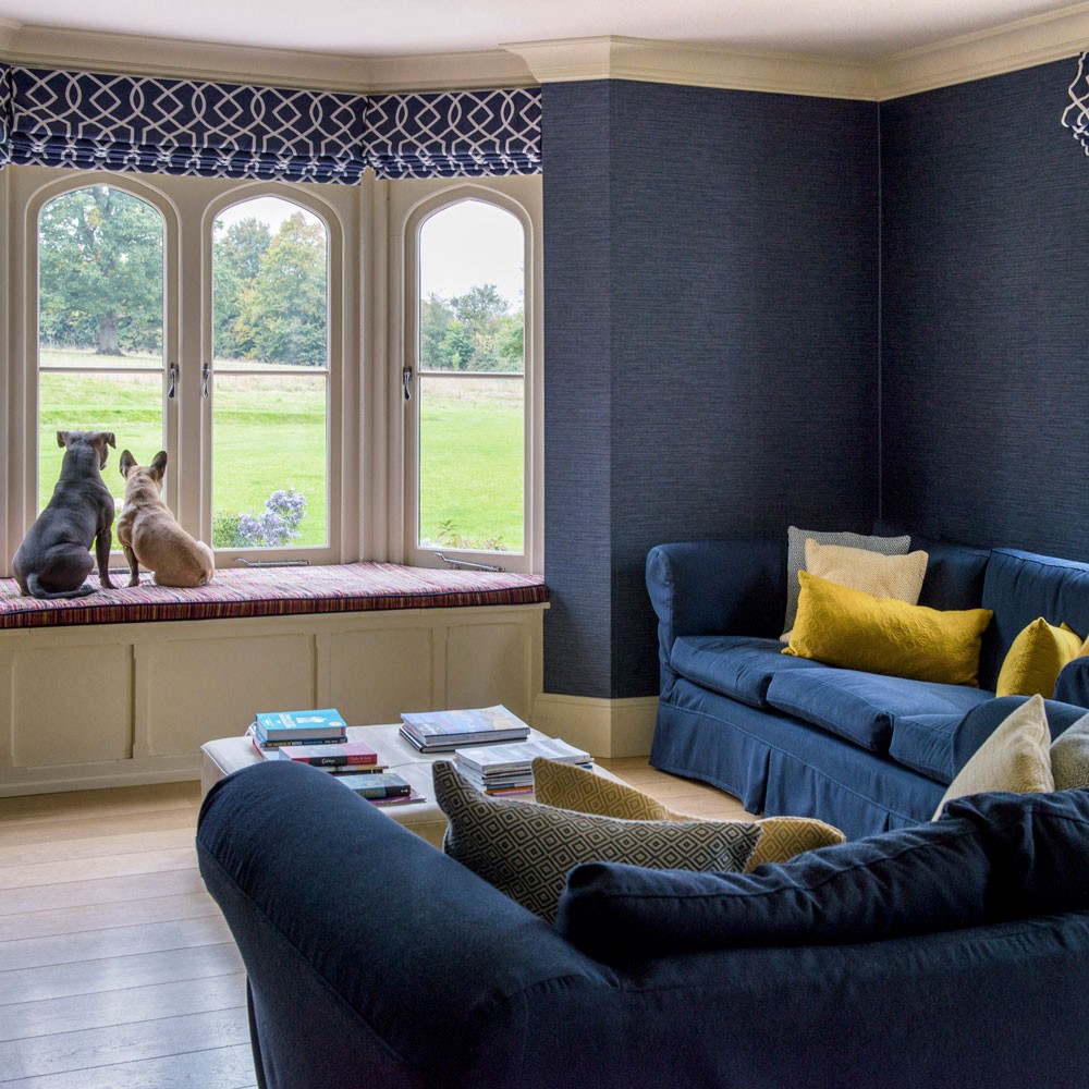 blue living area with sofa and yellow cushions