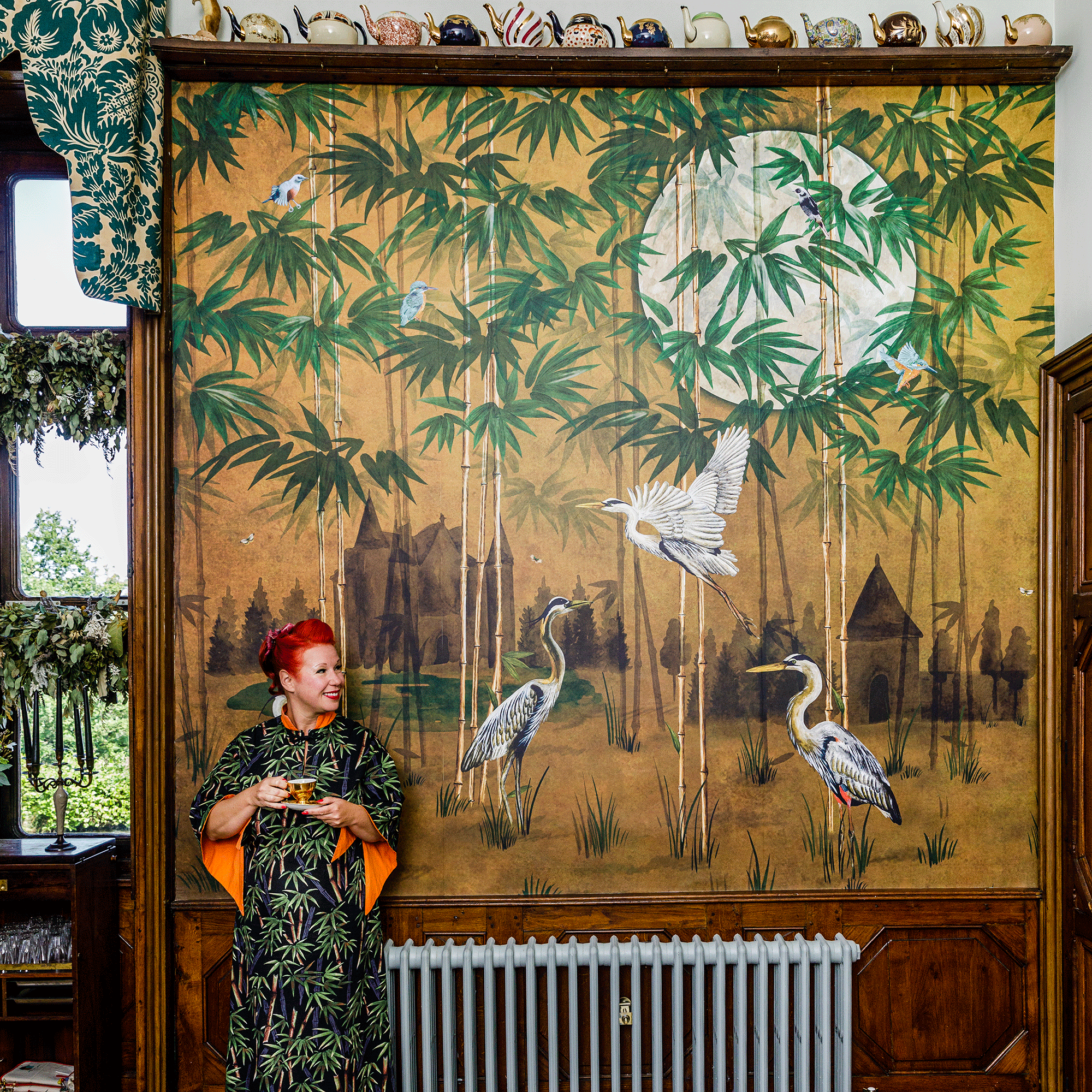 Angel Strawbridge in front of wall mural