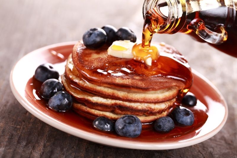 maple syrup on a stack of pancakes