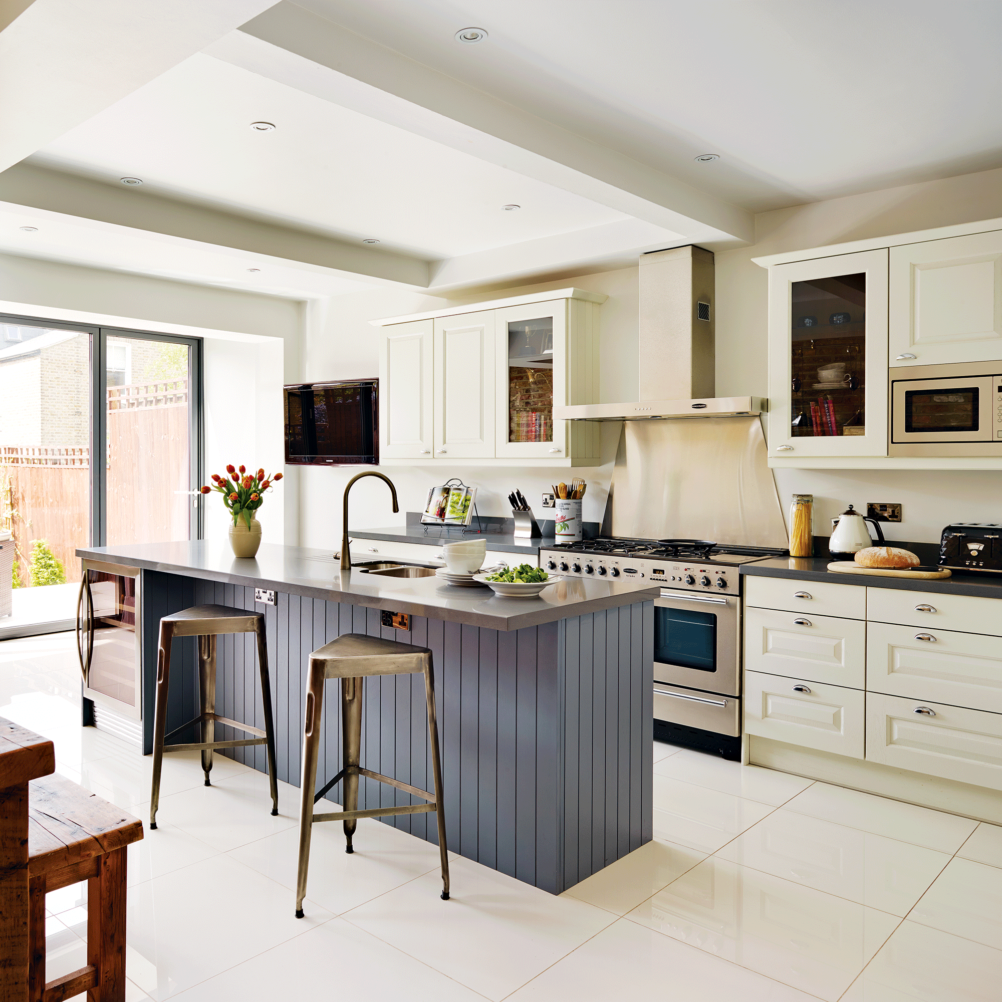 Open plan kitchen with blue island