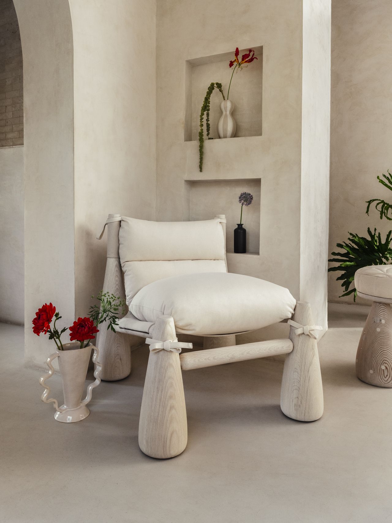 Chunky-looking furniture items including armchairs, chairs, stools, coffee tables, and sofas boast an organic feel and pleasing surface against a cream background.