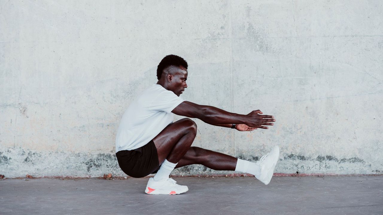 a man performing a pistol squat