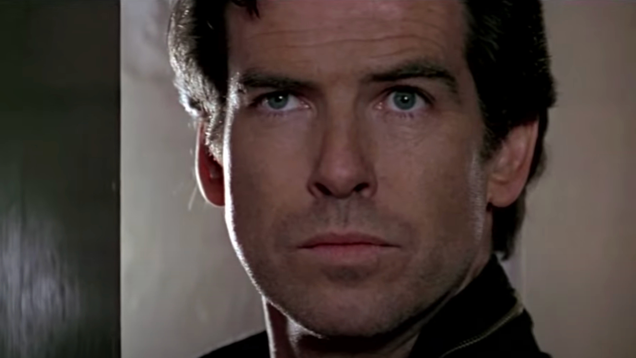 Pierce Brosnan cautiously stands in a doorway in Goldeneye.
