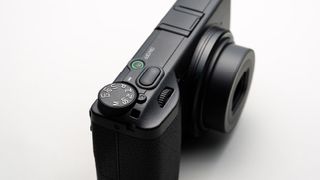 The Ricoh GR IV photographed from the top front on a white background