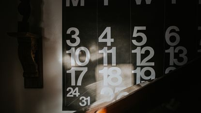 Sunbeams on a wall calendar showing one month.