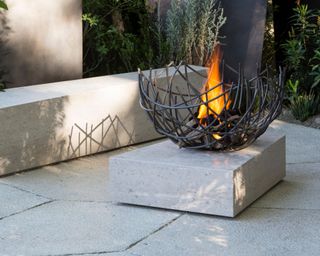 garden bench ideas modern stone patio with bench seat and outdoor firepit designed by Andy Sturgeon
