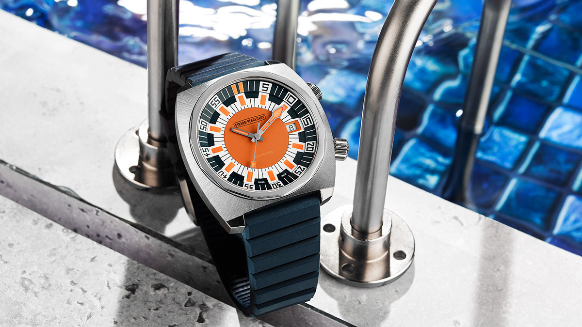 Navy blue and orange watch in front of some swimming pool steps