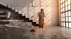 A woman talks on her cell phone while standing in her flooded house.