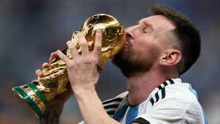 Lionel Messi kisses the World Cup in Qatar