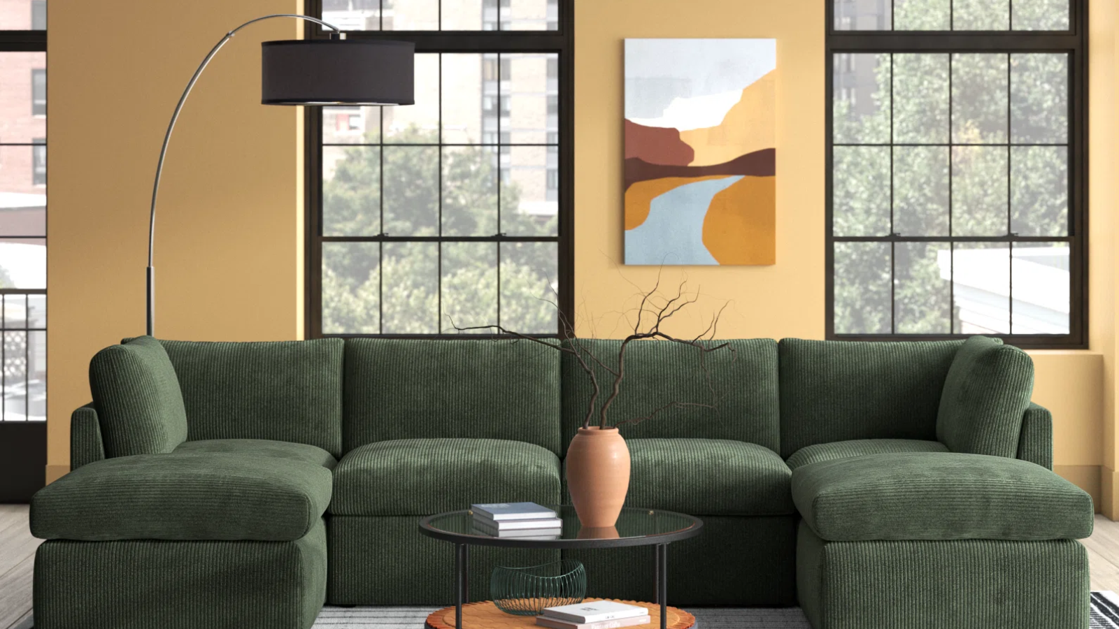 a living room with a green couch and a lamp