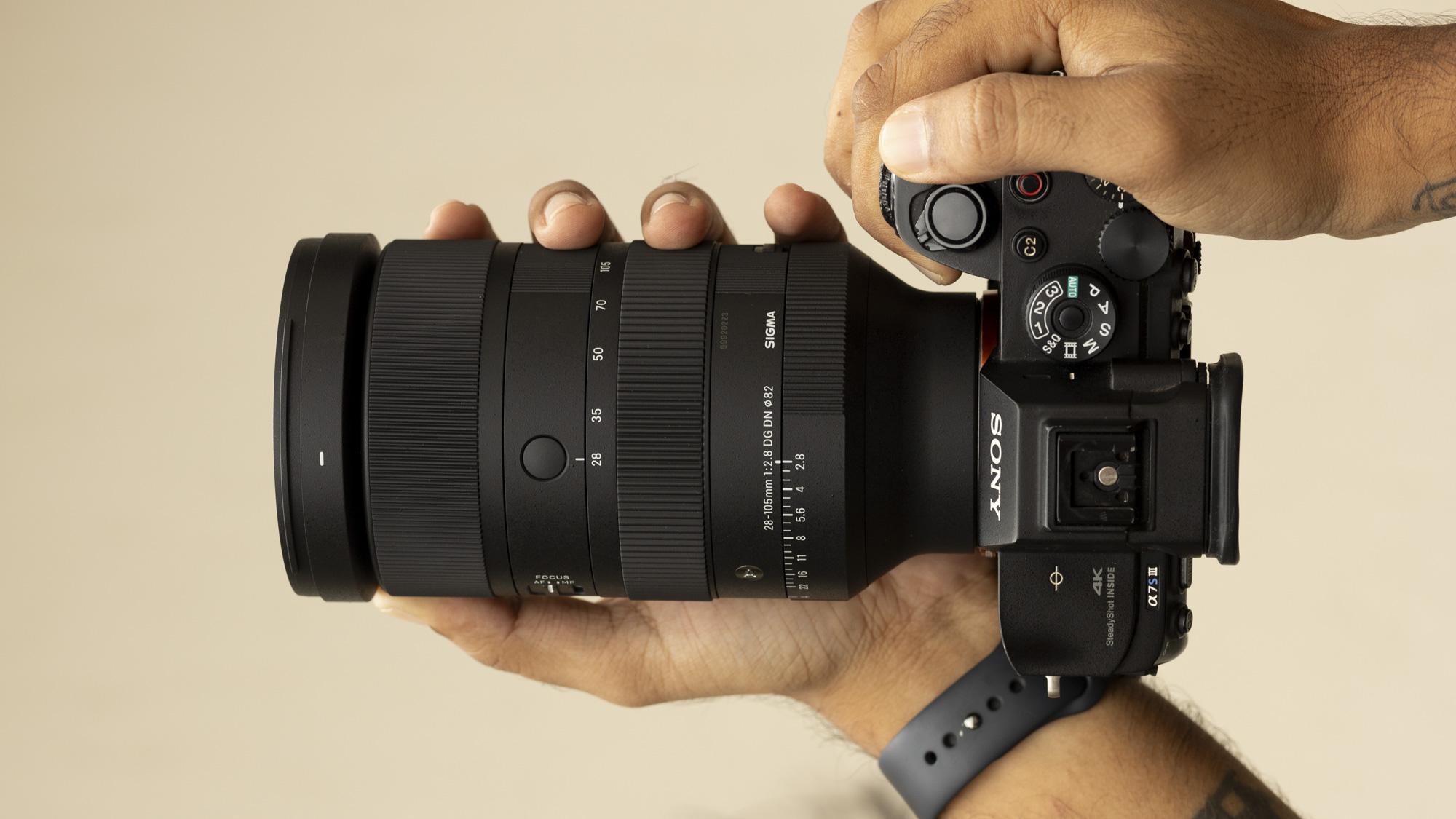 Hands on the Sigma 28-105mm F2.8 DG DN lens attached to a Sony camera