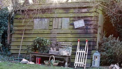 Garden shed in winter with potting shed sign