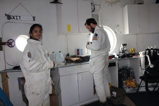 Mars 160 crewmembers Anushree Srivastava and Paul Knightly prepare for an extravehicular activity.