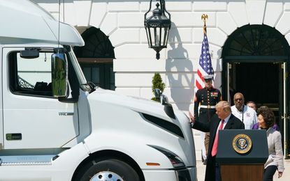 President Trump pats a truck.