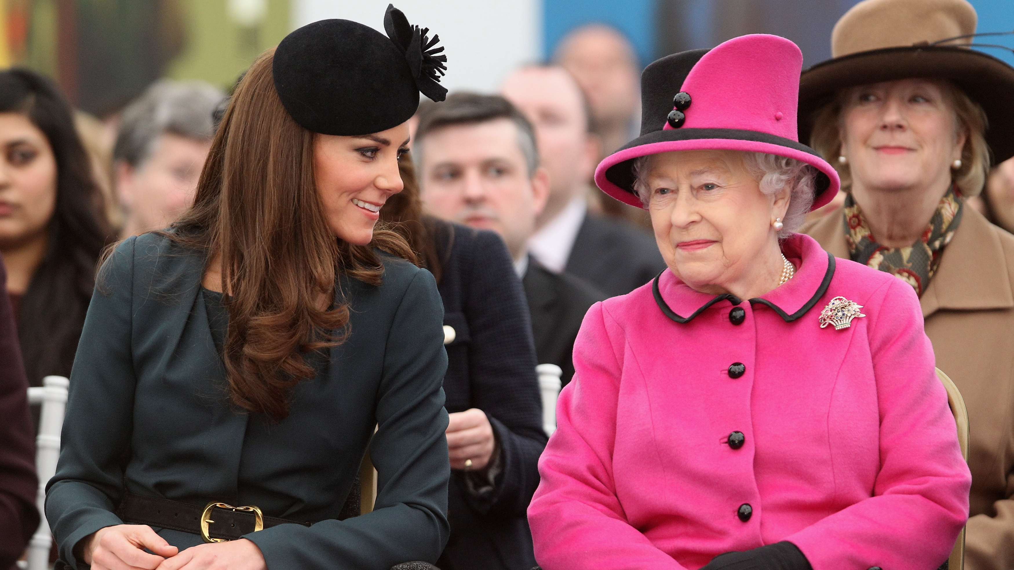 Queen Elizabeth II and Catherine, Princess of Wales watch a fashion show at De Montfort University on March 8, 2012