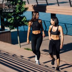 Two women on a run together by the river