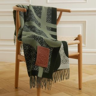 green patterned blanket draped on chair