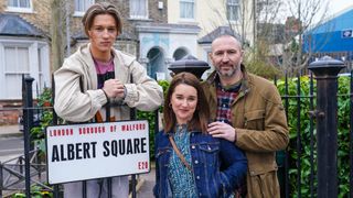 Joel (MAX MURRAY), Vicki Fowler (ALICE HAIG), Ross (ALEX WALKINSHAW) standing by the Albert Square sign in EastEnders