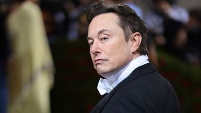Elon Musk looking over his shoulder