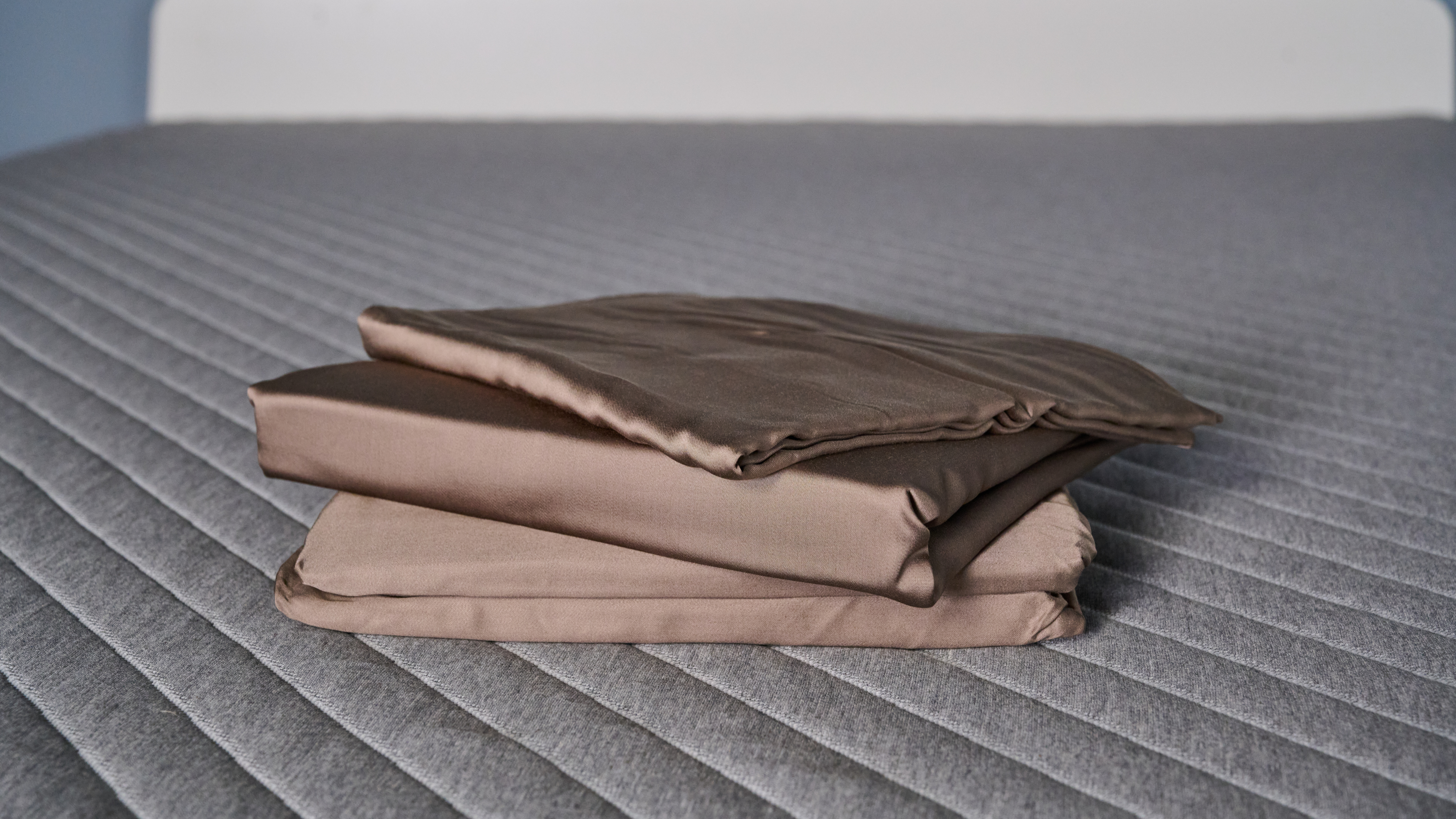 Cozy Earth bamboo sheet set in walnut brown stacked on the bed