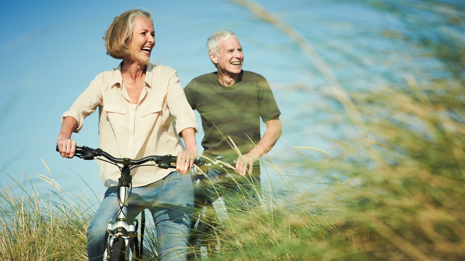 Senior couple riding their bikes in the sunshine