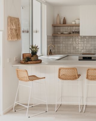white kitchen with breakfast bar and seating