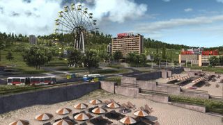 An image of a seaside resort and hotel from Workers & Resources: Soviet Republic. There are umbrellas long the beach and a ferris wheel in the background.