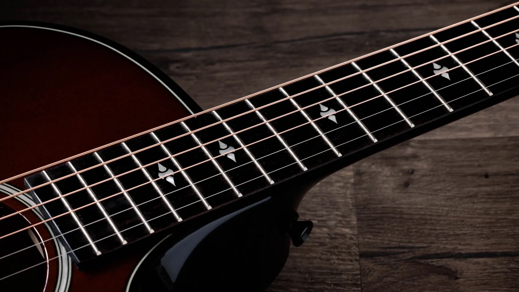 A photo showing a detail of the Taylor Next Generation 514ce Builder&rsquo;s Edition in Kona Burst