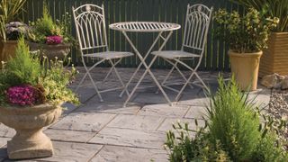 small patio with bistro set and planters