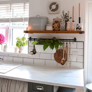 white kitchen with wooden shelf and worktop