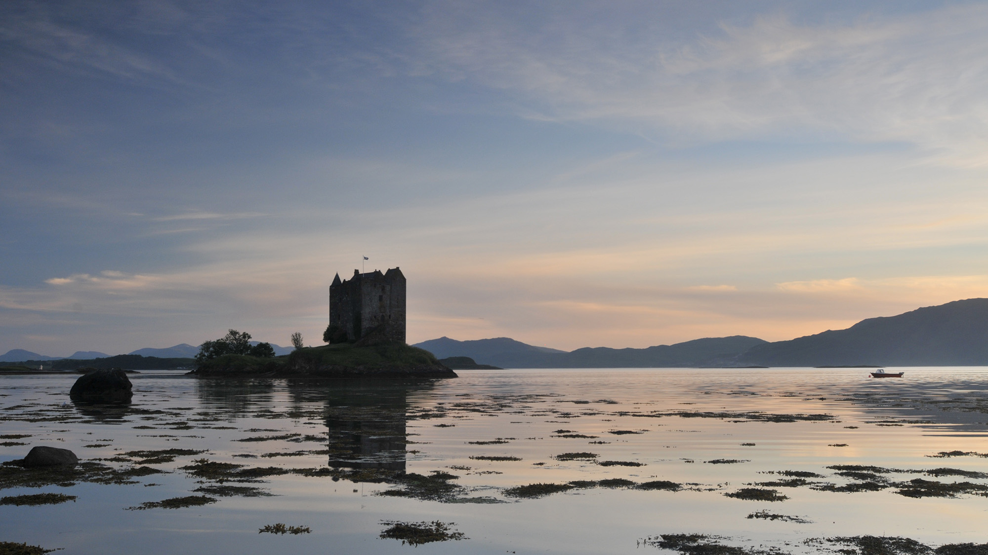 Castle on a loch, at dusk