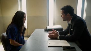 Fiona Rene as Glory Days and Manuel Garcia-Rulfo as Mickey Haller talking in jail in The Lincoln Lawyer season 2